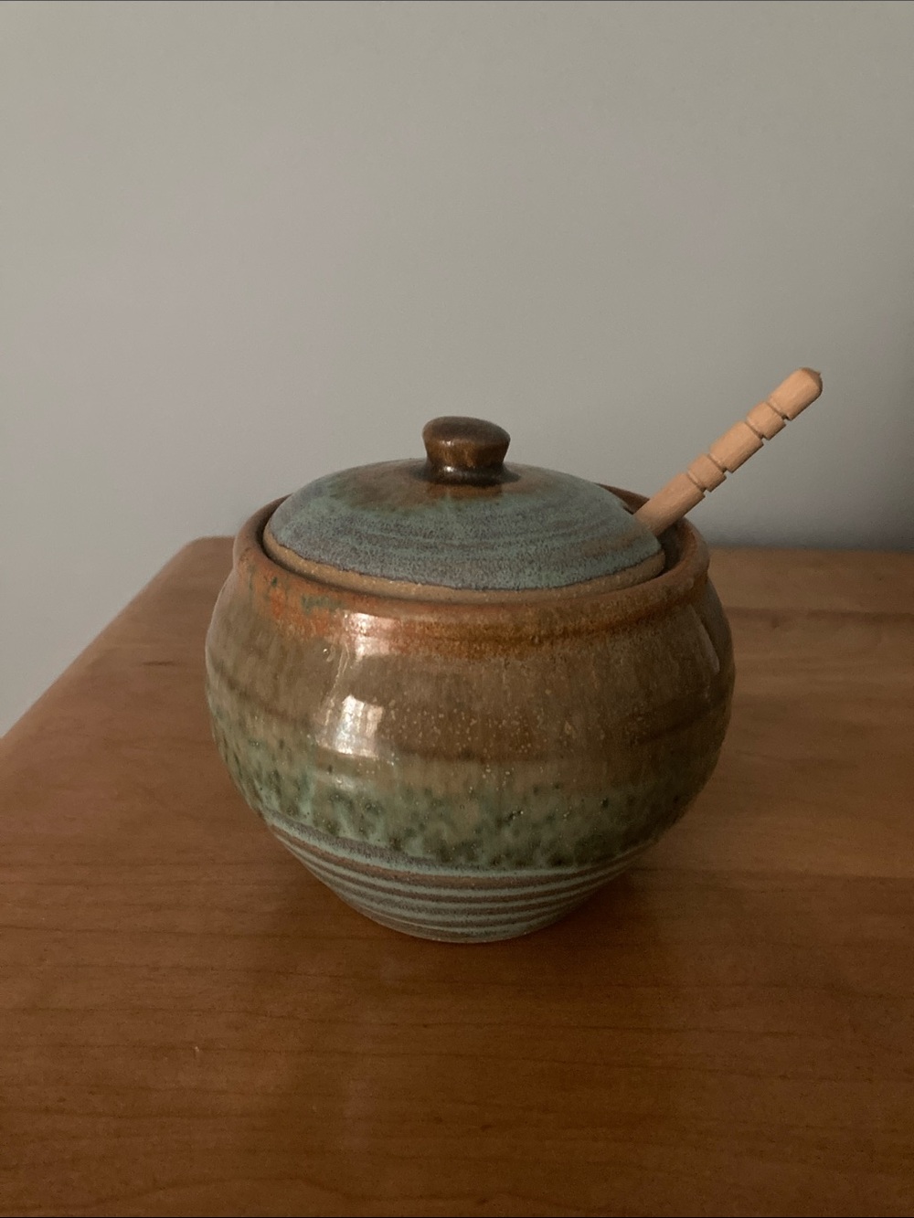 Handmade Pigeon River Pottery honey pot colors of green and blue and brown